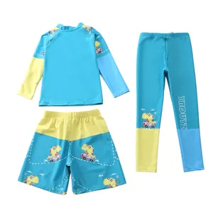 Completo da bagno per bambini in tre pezzi con maglia a maniche lunghe e dinosauri