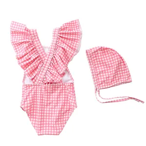 Pink and white gingham baby swimsuit set with ruffled sleeves and matching sun hat
