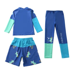 Dettaglio dell'abbigliamento da nuoto tre pezzi blu navy per bambini con dinosauri