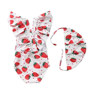 Detail of red strawberry print swimsuit for girls with matching frill cap set