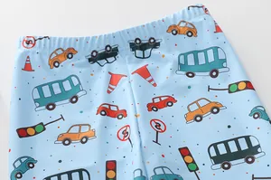 Détail de la taille de maillot de bain enfant avec motifs voitures sur tissu bleu