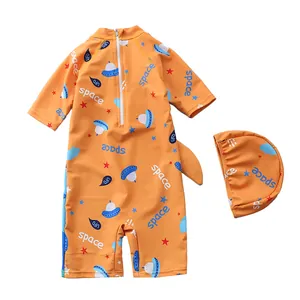 Detailed view of orange kids sun protection swimwear with space pattern and matching swim cap