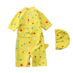 Flat lay of boys yellow long sleeve swimsuit set with colorful star pattern and swim cap