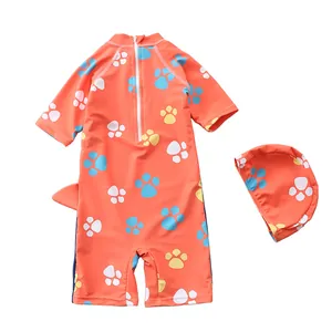 Detail of toddler boy hooded swimwear with orange paw prints and a unique 3D fin design