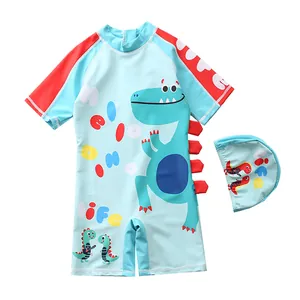 Detail of boys cartoon dinosaur swimsuit with 3D fins and matching swimming cap