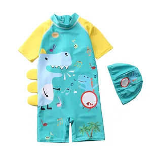Detail view of boys' dinosaur one-piece swimsuit with matching hat and side 3D fins