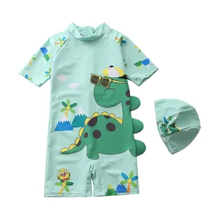 Detail of mint green boys' dinosaur swimsuit with 3D decorative fins and matching swimming cap