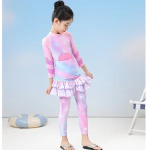 Detail of girls two-piece long sleeve swimsuit with ruffle skirt and sea star pattern