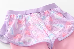 Detail of girls' swim shorts featuring lavender mesh with shell prints and inner layer