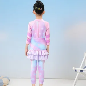 Detail of girls long sleeve swimsuit with pink zipper and colorful star pattern
