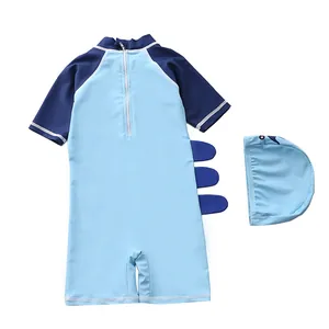 Detail of blue shark fin style boys one-piece swimwear with zipper and matching swim cap