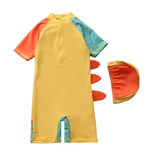 Flat lay of yellow kids dinosaur swimsuit with hooded cap and orange back fins details