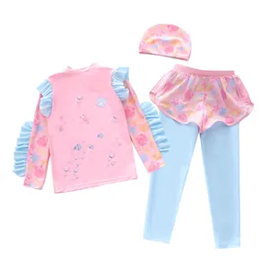 Detailed flat lay of kids three-piece swimsuit with ruffled sleeves and ocean shell patterns