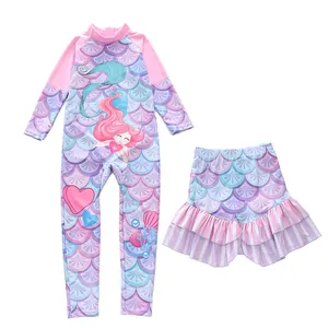 Detail of girls two-piece long sleeve swimsuit with pink mermaid scale pattern and skirt