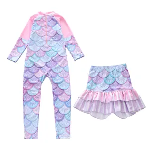 Macro detail of kids long sleeve mermaid swimsuit with ruffled skirt and scale patterns