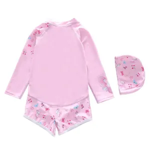 Detail view of pink long sleeve kids swimsuit with cartoon unicorn and flower patterns