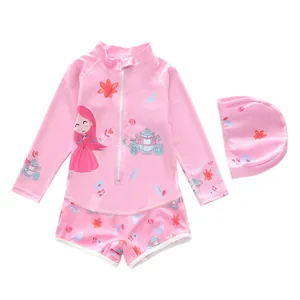 Detail of pink long-sleeved girls' swimsuit with cartoon princess prints and matching swim cap