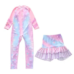 Detail of girls' long-sleeve swimwear with dreamy gradient ocean patterns and pleated skirt