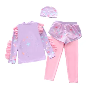Close-up of children's four-piece swimwear set with ruffles and sea creature prints