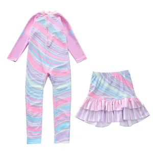 Detail of girls' long sleeve swimsuit set featuring pink purple wave prints and ruffled skirt