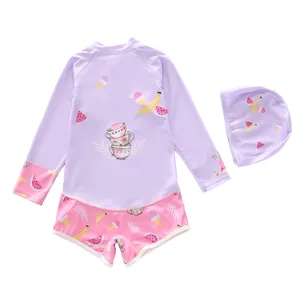 Detail of girls long sleeve swimsuit set with cute cartoon patterns and matching swim cap