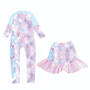Detail of girls' long sleeve swimsuit set with colorful abstract marble print and ruffle skirt
