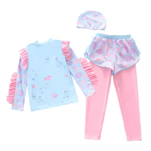 Detailed view of girls' three-piece long sleeve swimwear with ruffles and ocean print