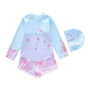 Detail view of girls long sleeve floral swimsuit set with matching swim cap on white background