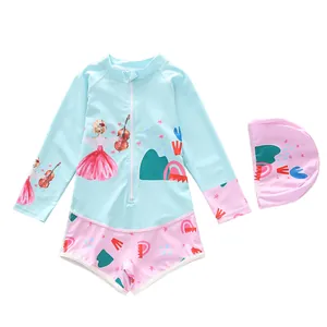 Detail of girls' long-sleeve swimsuit with cartoon girl print and matching swimming cap