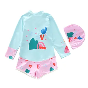Detail of girls' long sleeve swimsuit with pink swimming cap and star pattern