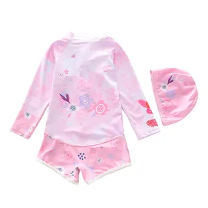 Close-up of pink long sleeve floral swimsuit set with swim cap for girls
