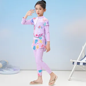 Detailed view of girls' purple long-sleeve swimwear with mermaid and shell patterns