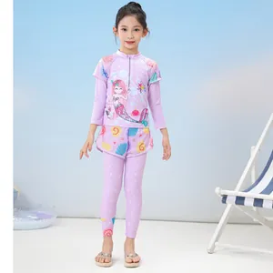 Detailed view of girls purple mermaid swimsuit set with long sleeves and shell patterns