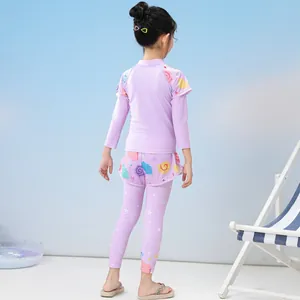 Three-piece girls swimwear with long sleeves and pants featuring seashell and star prints