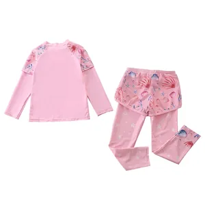 Detailed flat lay of girls' long sleeve swimwear set featuring pink ocean life patterns