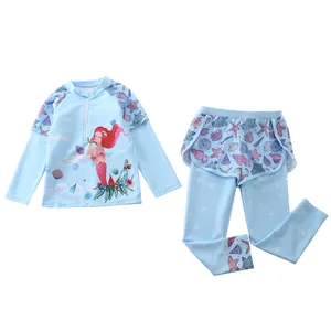 Detail of girls two-piece long sleeve swimwear set featuring a mermaid print and ruffled skirt