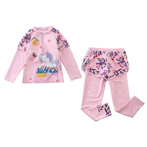 Detail of girls' long sleeve swimwear featuring unicorn prints and floral patchwork design