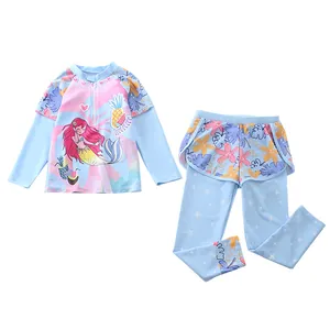 Detail of girls' two-piece long-sleeve swimsuit featuring mermaid print and floral skirt