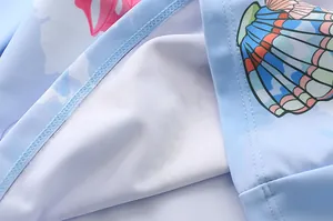 Detailed macro view of girls' swimsuit fabric with shell print and double stitching