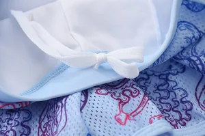 Macro detail of breathable light blue mesh fabric and drawstring of kids' swimwear