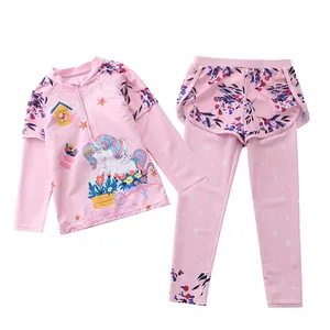 Detail of girls pink two-piece long sleeve swimwear with unicorn and floral print