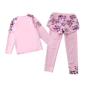 Detail of girls floral pink two-piece long sleeve swimsuit and leggings set