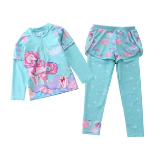 Detail view of girls long sleeve mint green unicorn swimwear set with rainbow patterns