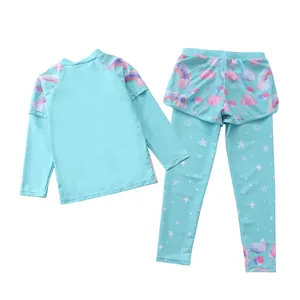 Detail of mint green girls' two-piece swimwear with rainbow prints and long sun protection pants