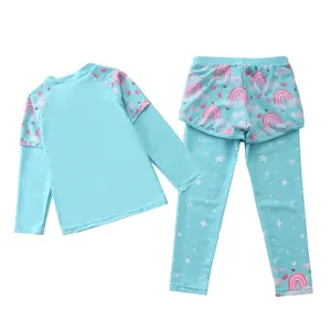 Detail of girls two-piece swimsuit with rainbow print long sleeves and skirted leggings