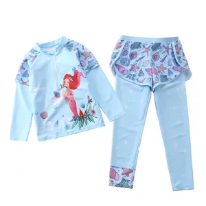 Detail of two-piece long sleeve girls swimwear with mermaid print and floral pattern