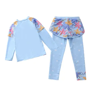 Flat lay of a girls two-piece long sleeve swimsuit set with floral prints and star patterns