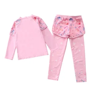 Detail of pink long-sleeve kids' swimwear set with starfish patterns and tiered swim pants