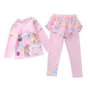 Close-up of pink long-sleeve swim top with unicorn print and tiered skirt leggings