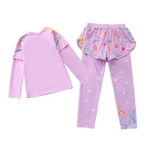Detail of purple long-sleeve girls' swimwear featuring sea star prints and mesh skirt overlay